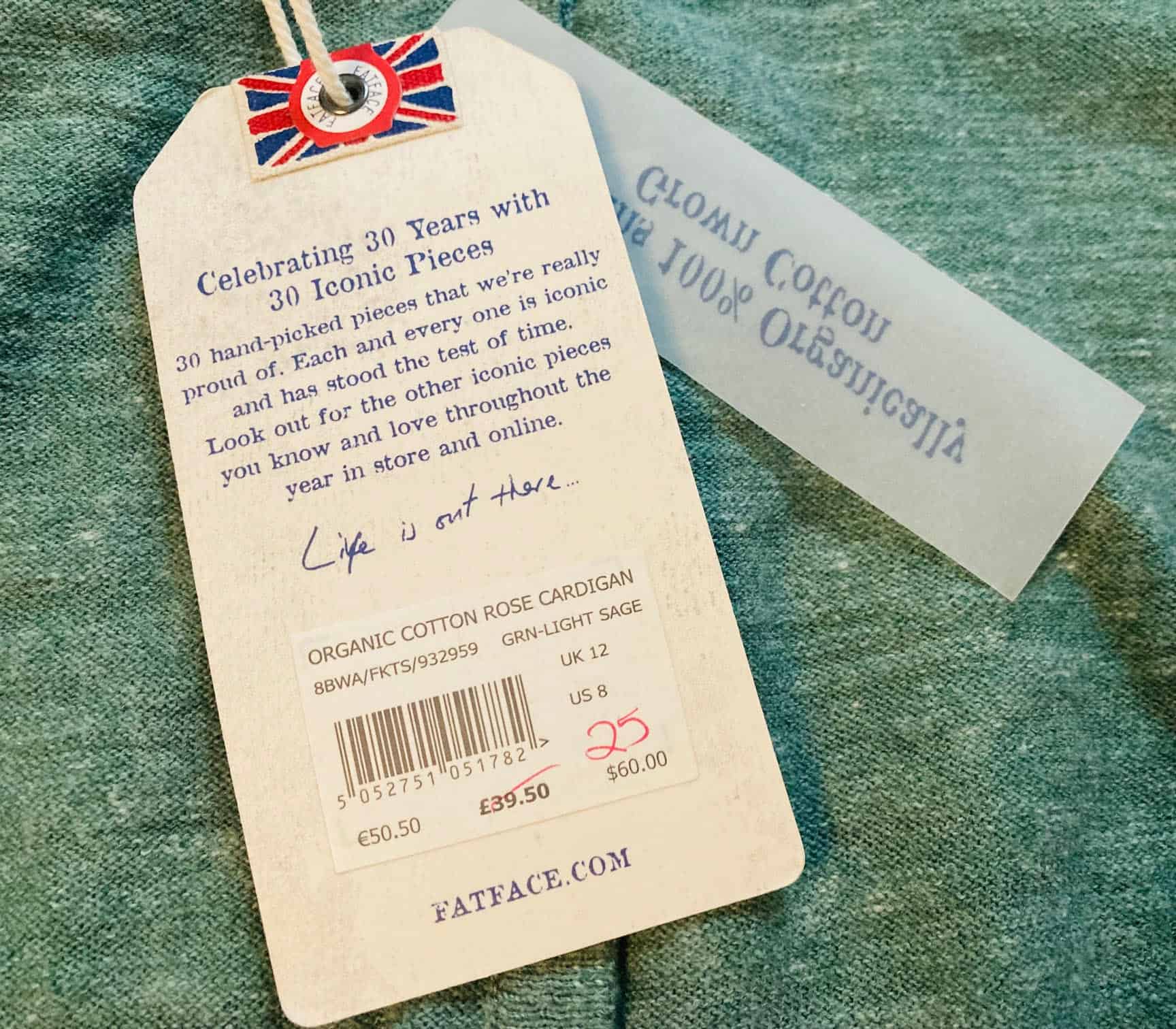 Close up of a label with £39.50 crossed out and £25 written on in red pen