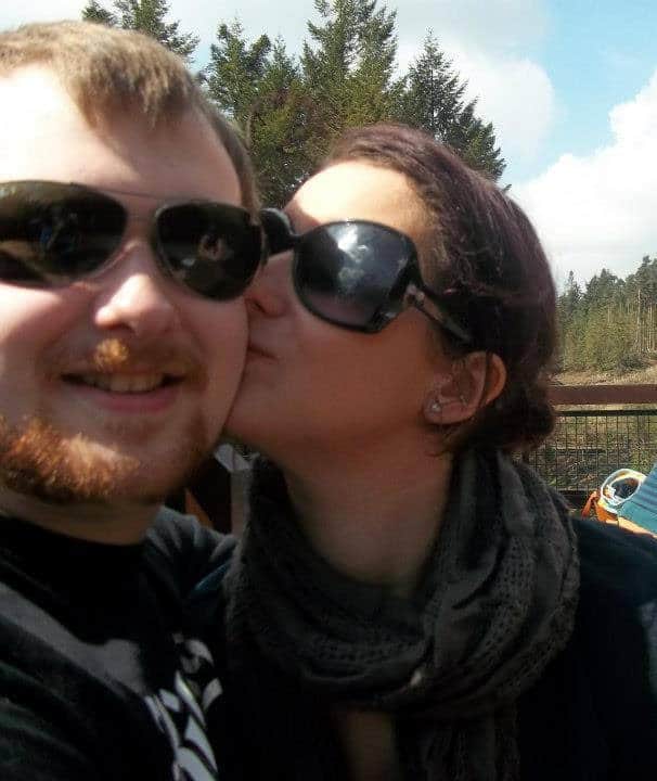 My husband and I say outside the Pancake house at Center Parcs. We are bother wearing sunglasses.